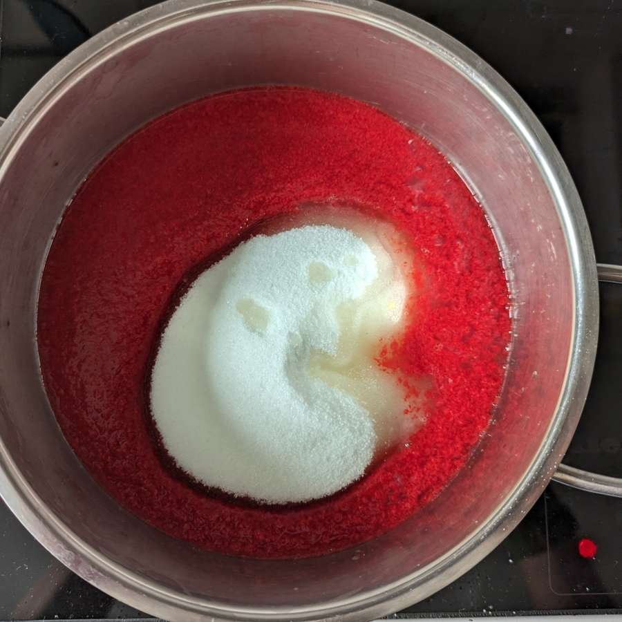 Granulated sugar and lemon juice added to Cornelian cherry pulp before boiling.