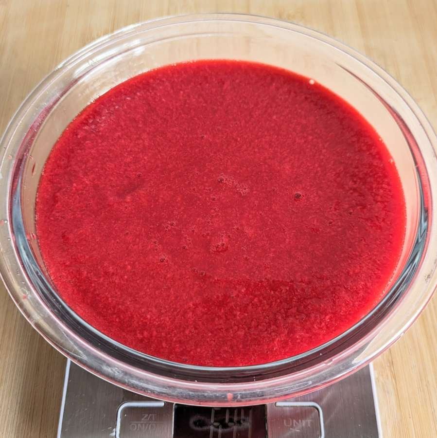 Strained Cornelian cherry pulp being weighed before adding sugar.