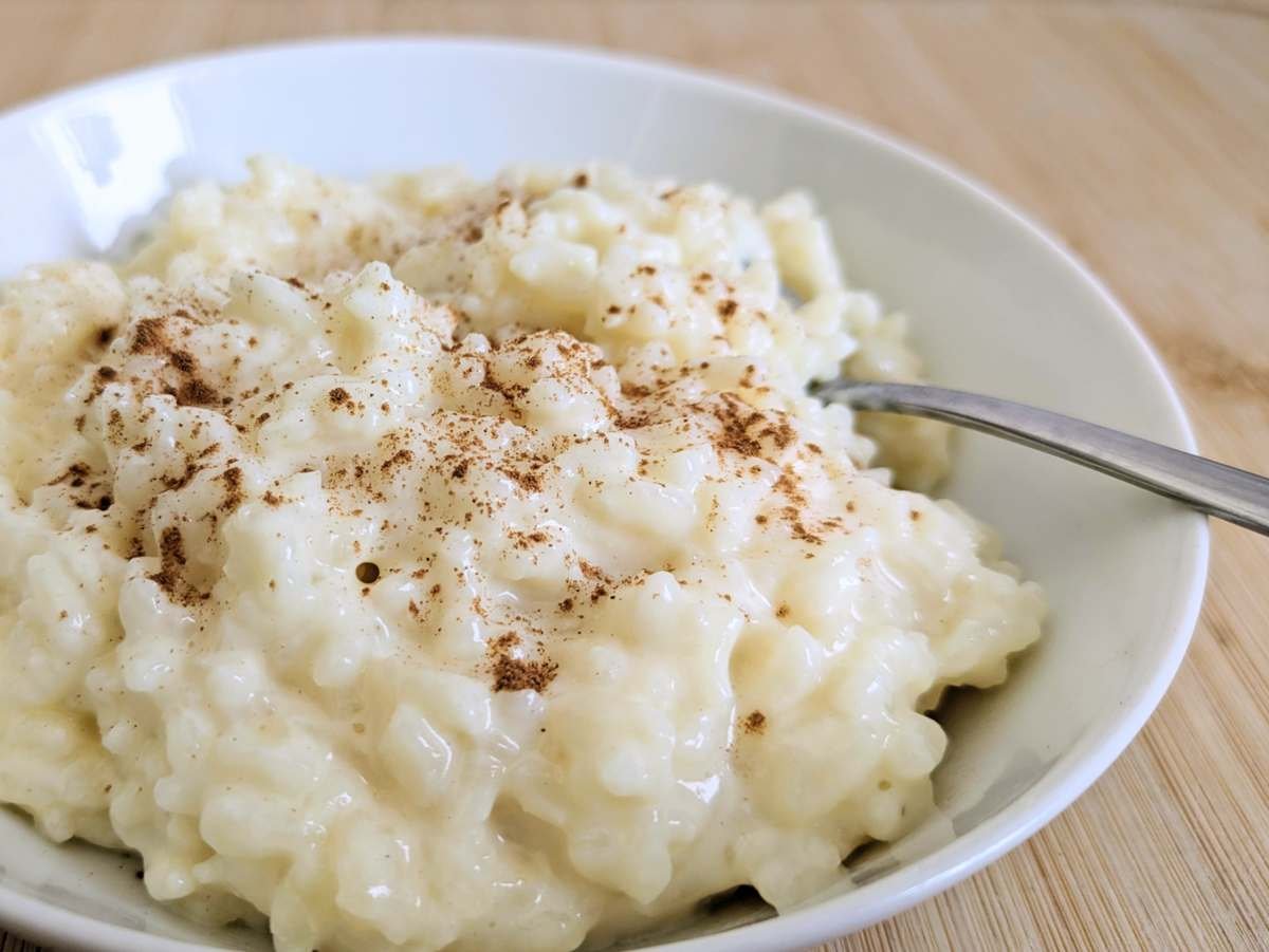 Close-up of creamy Instant Pot rice pudding sprinkled with cinnamon.
