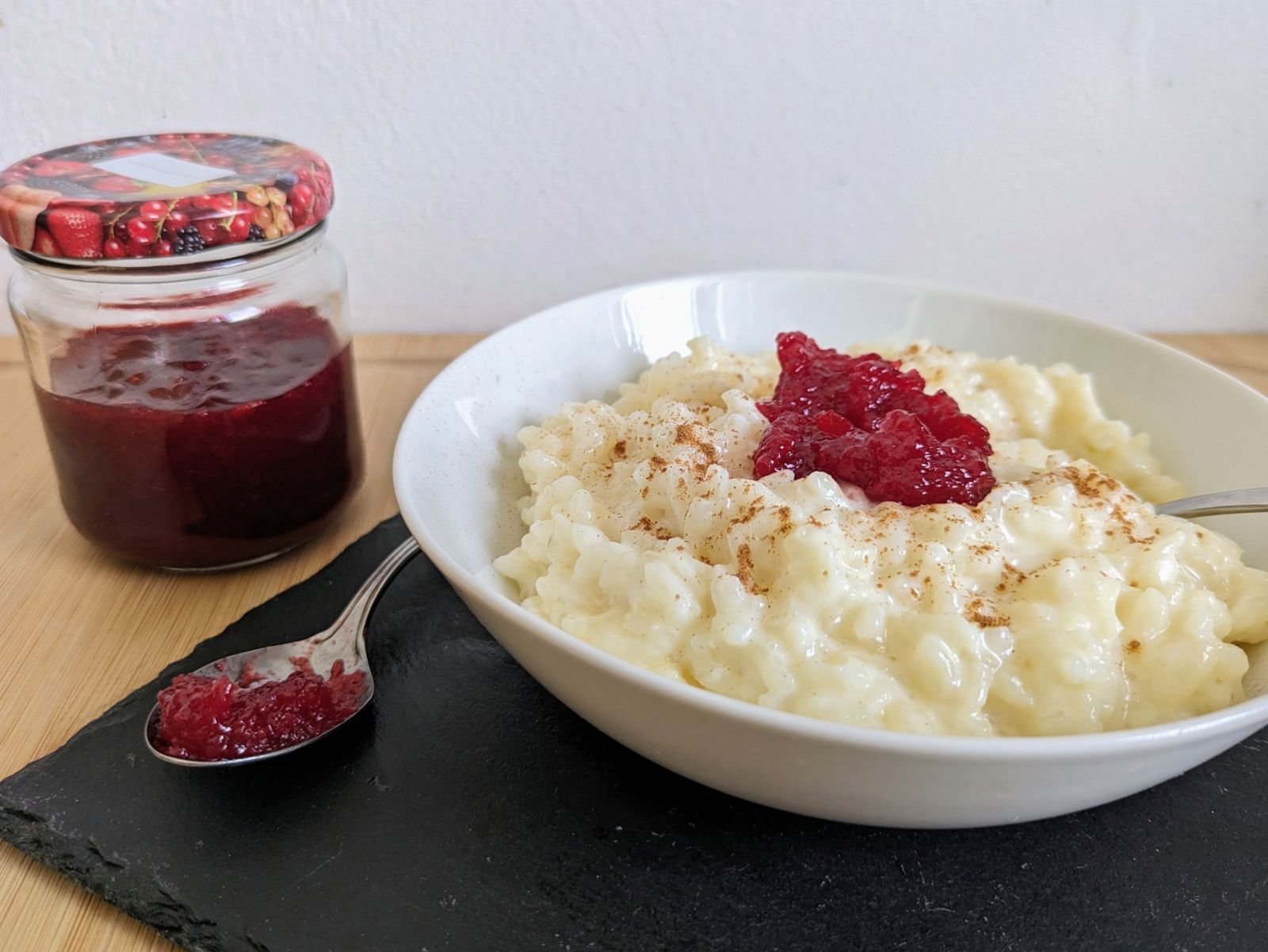 Instant Pot rice pudding served with cinnamon and Cornelian cherry jam.
