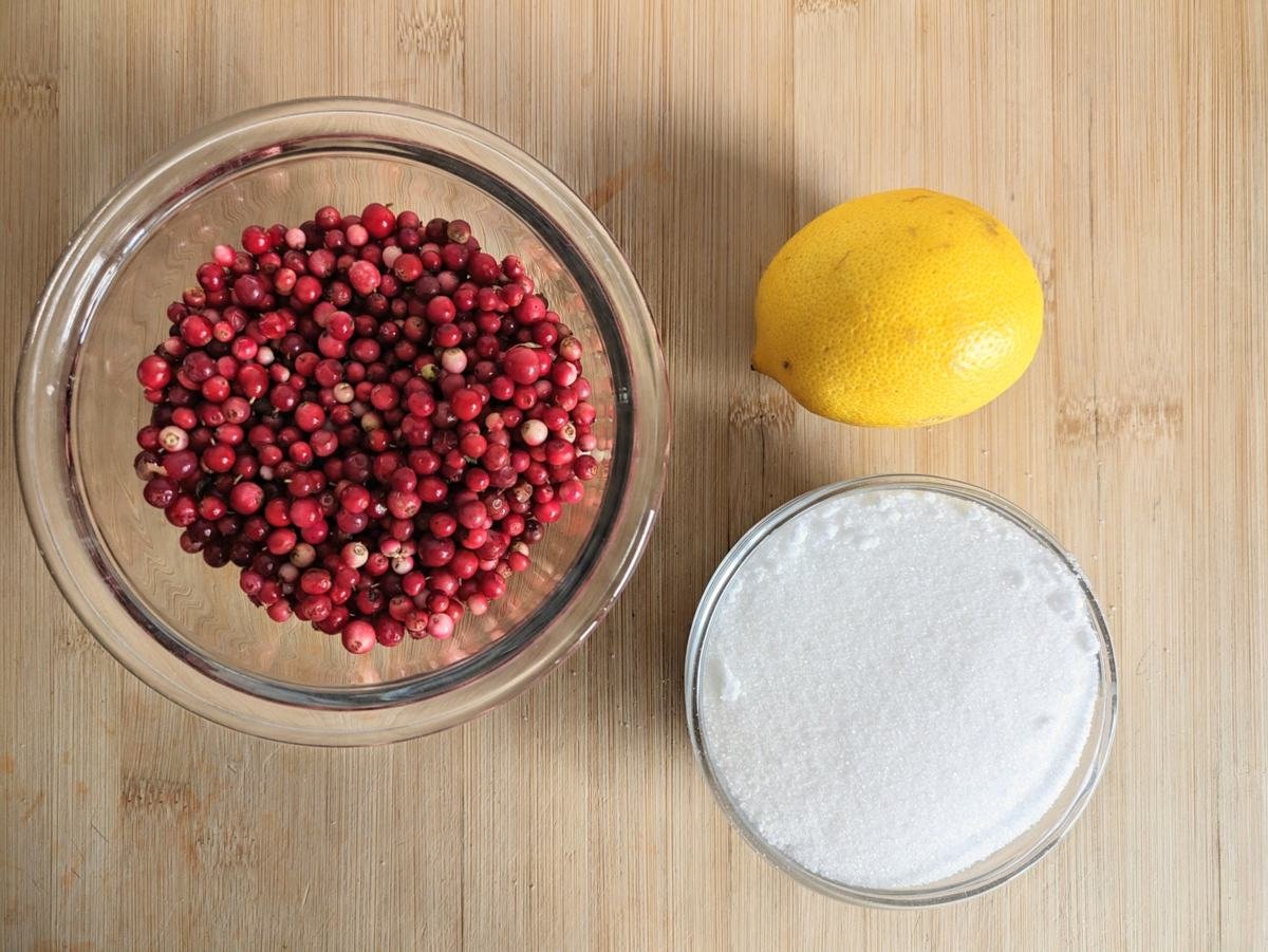 Fresh lingonberries, sugar and lemon used to make homemade lingonberry syrup.