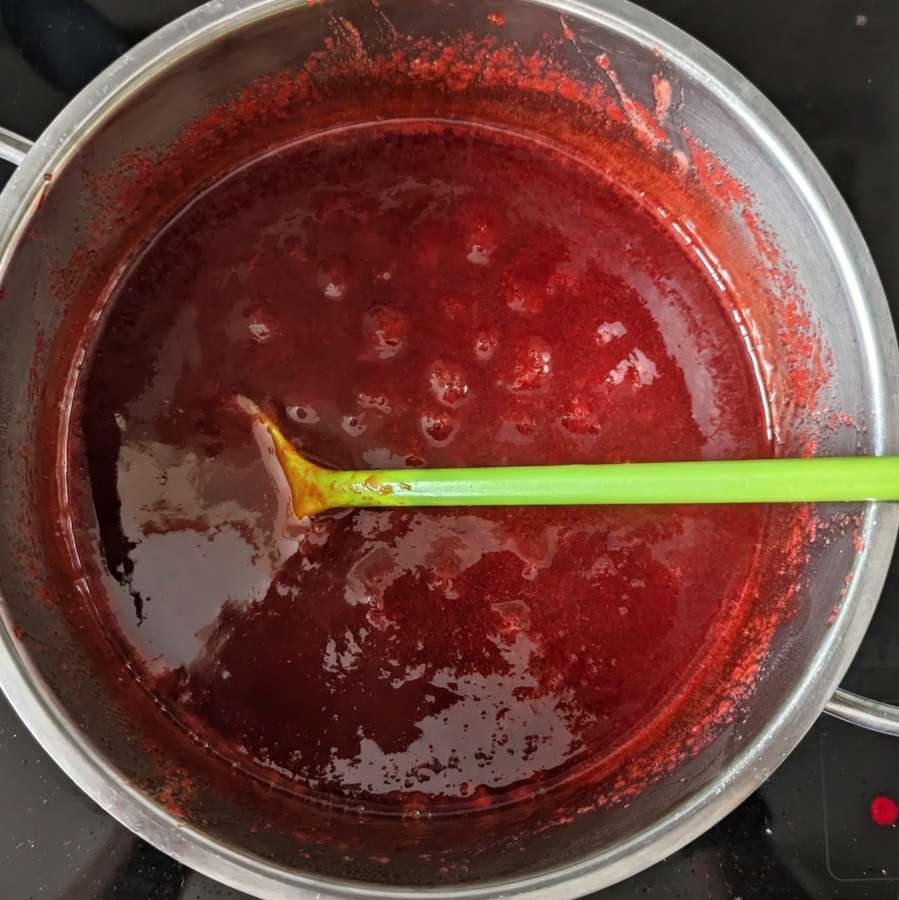 Cornelian cherry pulp simmering in a saucepan while making jam.