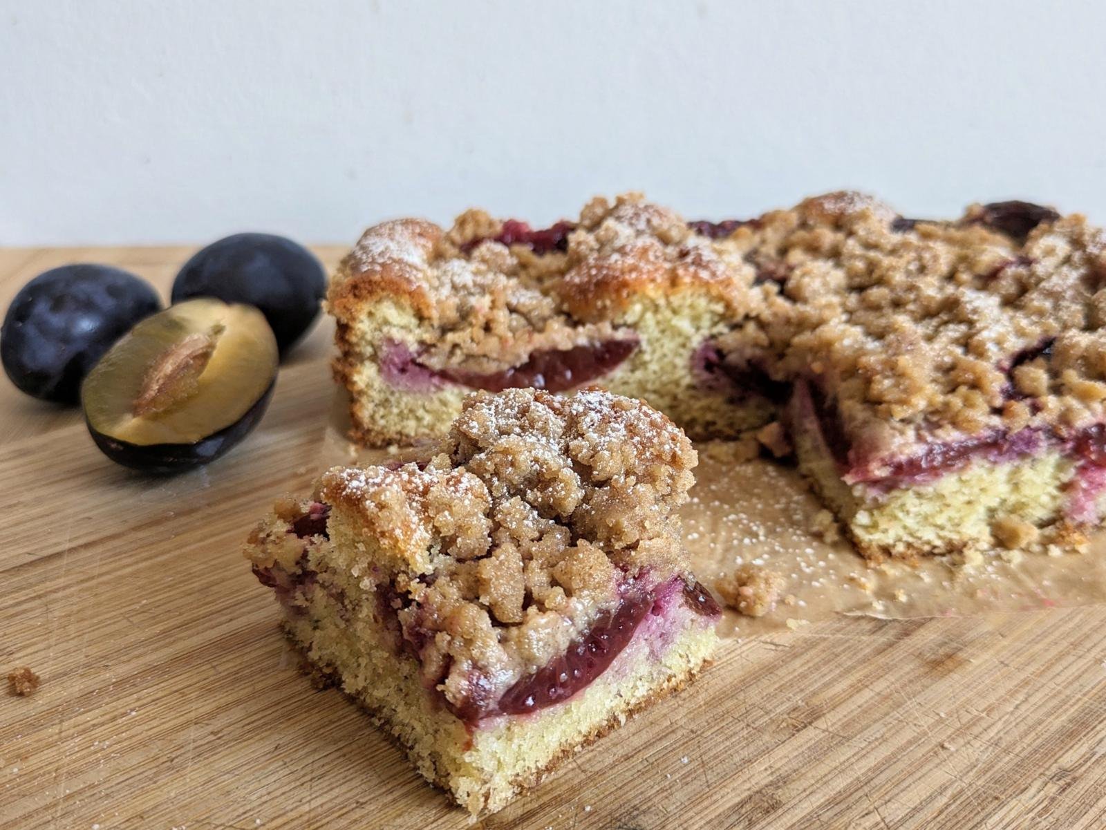Prune plum crumble cake cut into squares with juicy plum layers and a crisp streusel topping.