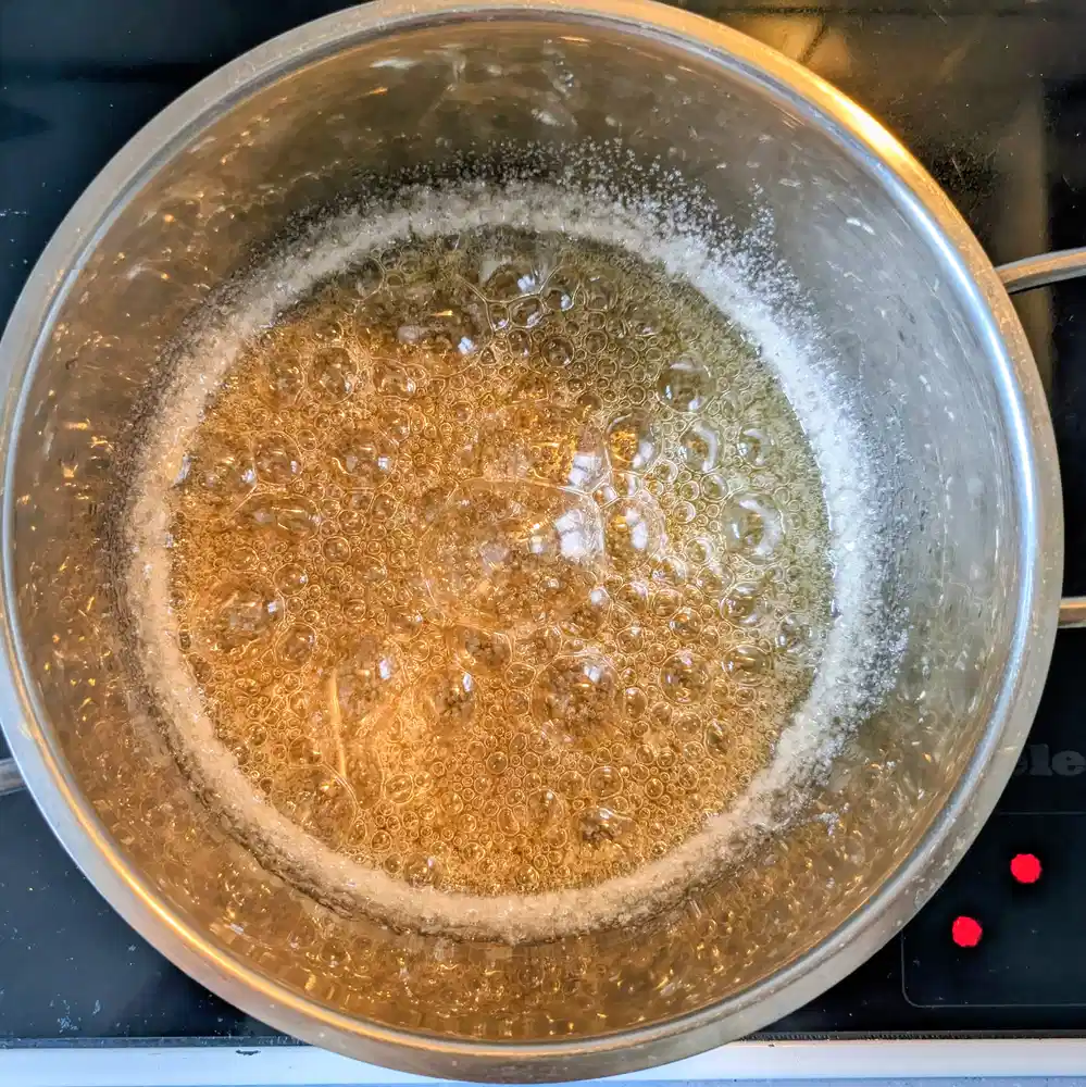 Golden caramel bubbling in a saucepan