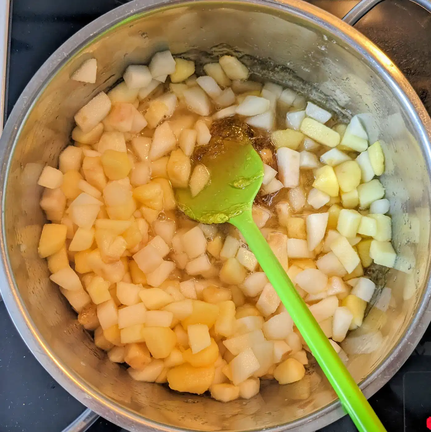 Diced apples stirred into golden caramel