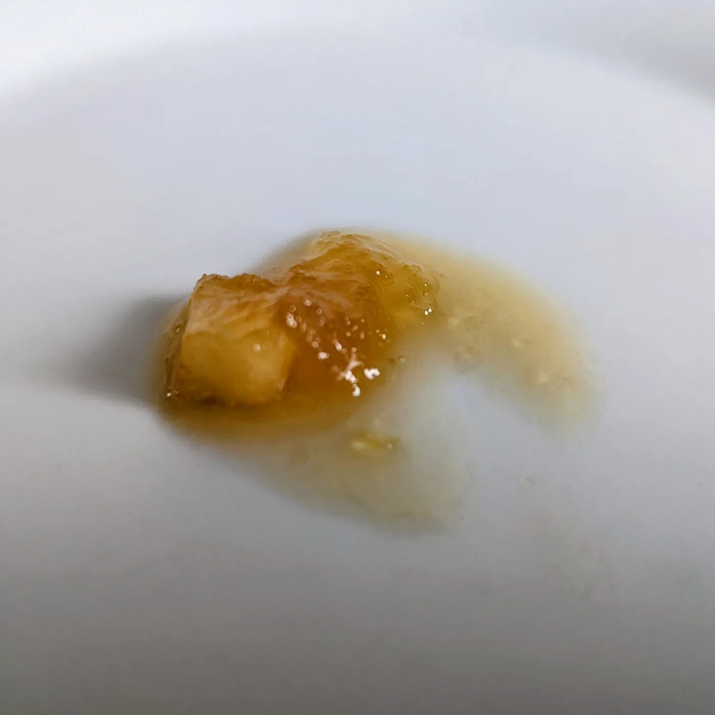 Small spoonful of jam on a white plate for a set test