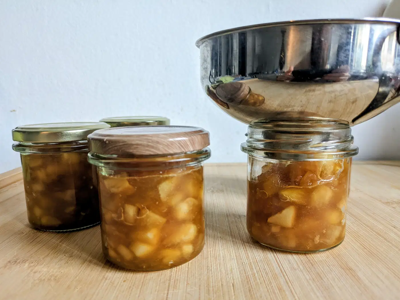Jars of toffee apple jam being filled